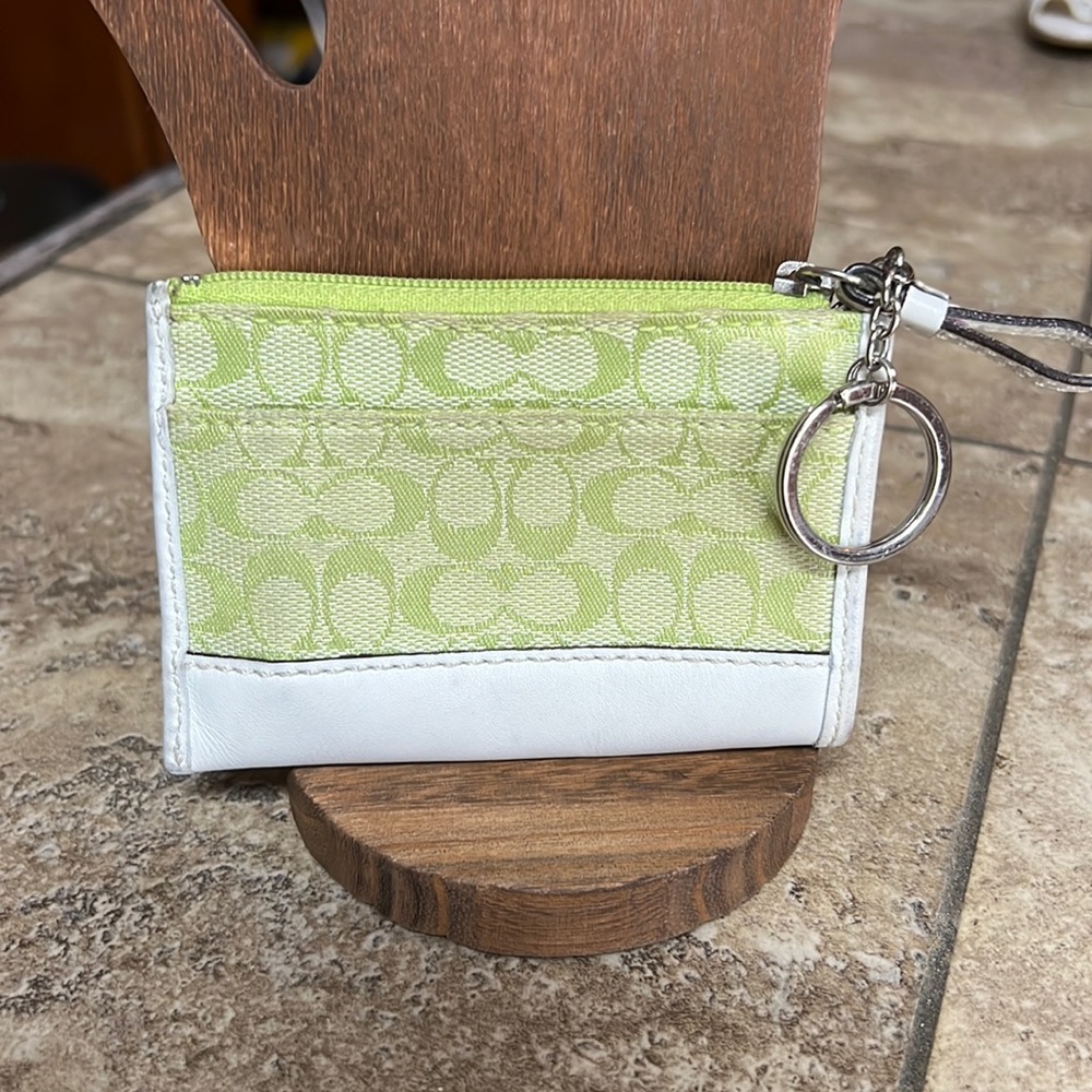 Small Coach wallet on a key chain.